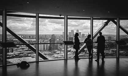 people with a view of a city in black and white