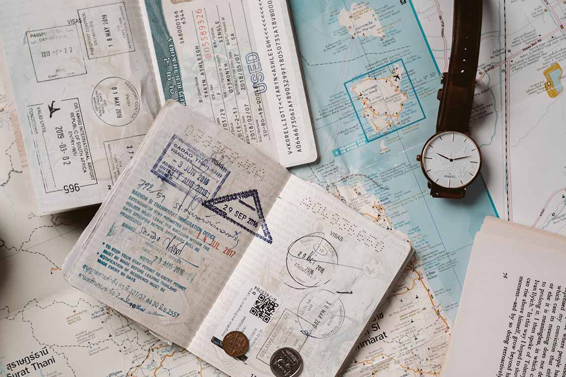 passports, maps and a watch laid out